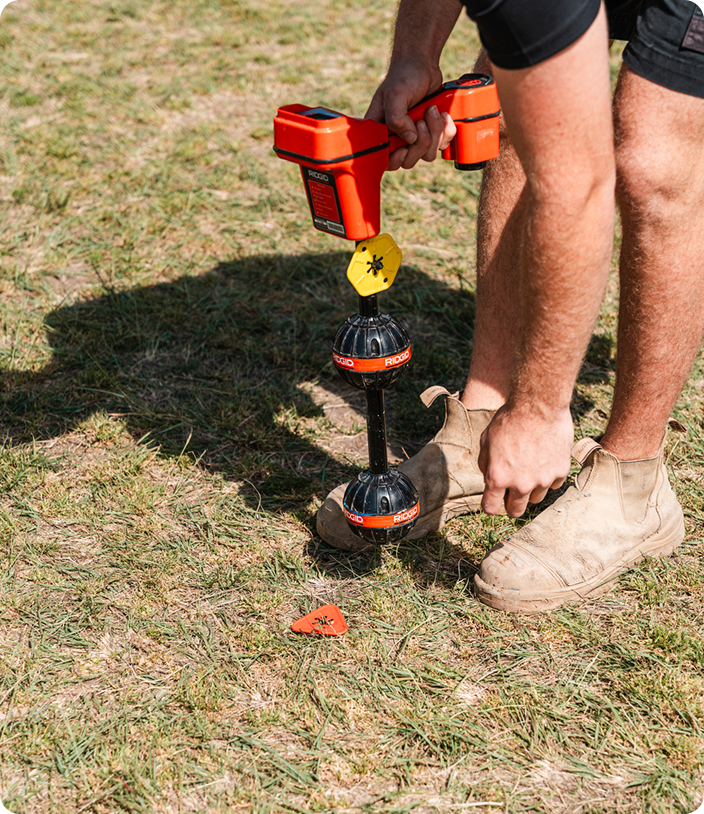 DYLSAL plumber using a Ridgid acoustic leak detector to pinpoint an underground leak